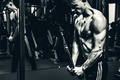 Man performing a physical exercise while maintaining concentration and determination during his workout